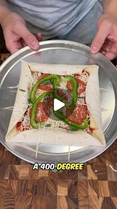 someone is making a pizza with peppers on it