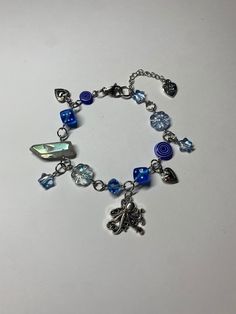 a bracelet with charms on it sitting on a table