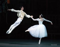 two ballerinas dressed in white and tuxedos