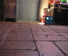 a toy train sitting on top of a brick floor