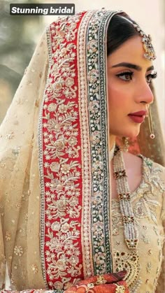 a woman wearing a red and white bridal outfit