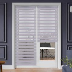 a living room with grey walls and white blinds