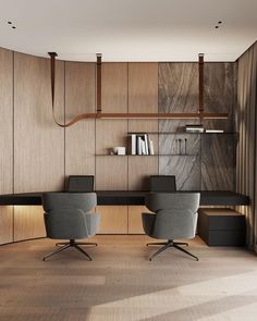 an office with two chairs and a desk in the middle, along with bookshelves