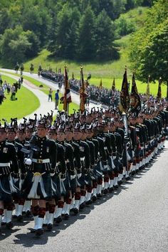 a large group of men in uniform marching down the street