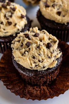 chocolate cupcakes with peanut butter frosting and chocolate chips on top, ready to be eaten