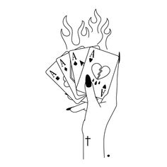 a hand holding four playing cards with flames coming out of them