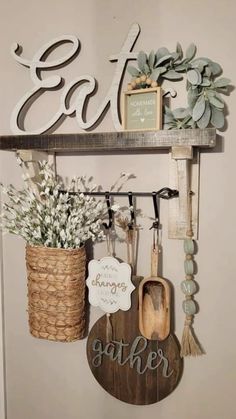 a wall mounted shelf with various items on it and the word eat hanging from it