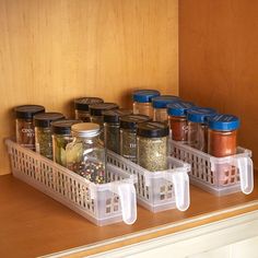 an organized spice rack in the corner of a kitchen counter with spices and seasonings