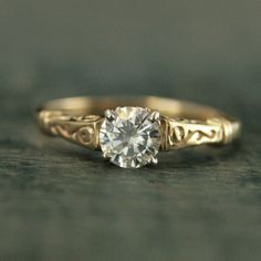 a gold ring with a diamond in the center