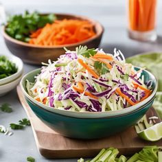 two bowls filled with coleslaw and carrots on top of a cutting board