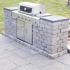 an outdoor grill made out of stone blocks