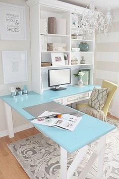 a home office with blue desk and white bookcases