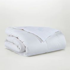 the comforter is white and has two pillows on it