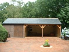 a wooden shed sitting in the middle of a garden