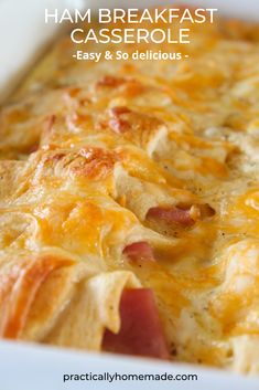 a casserole dish with ham, cheese and potatoes in a white baking dish