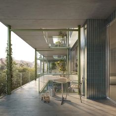 an outdoor patio with tables and chairs next to a building that has glass walls on both sides