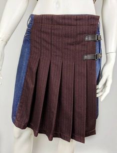 "Rare vintage denim wool skirt from Jean Paul Gaultier. Skirt kilt pleated tartan. The wrap skirt is fastened by a two black belt. Size I42 USA8 F38 (see measurements ) Condition 9/10 Color: blue denim and burgundy striped wool Made in Italy Waist - 39,5cm/15,55\" length skirt - 47,5cm/18,70\" All measurements taken with garment lying flat. Vintage sizes vary greatly! We recommend comparing measurements with a similar style garment you own for best fit! If you have any other questions, please co Brown Cotton Pleated Skirt For Fall, Jean Paul Gaultier Skirt, 90s Jean, Pleated Denim Skirt, Pleated Denim, Tartan Kilt, Wool Mini Skirt, Recycle Jeans, Vintage Rock