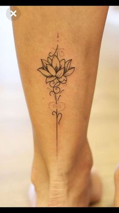 a woman's foot with a lotus tattoo on the lower part of her leg