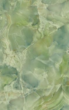 an abstract marble pattern with green and blue colors on the top, as well as some white