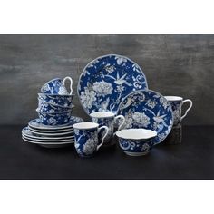 a blue and white china set with flowers on it