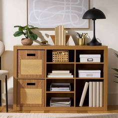 a book shelf with baskets and books on it