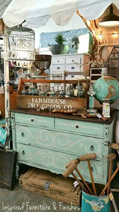 an old dresser is covered in antiques and other items for sale at the flea market