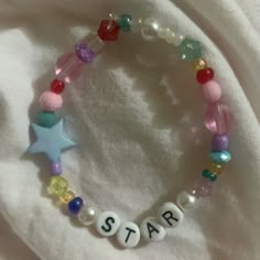 a bracelet that says star on it with beads and charms attached to the bead