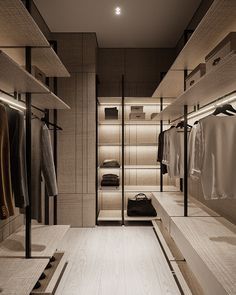 an image of a walk in closet with clothes hanging on the shelves and lights above