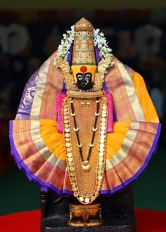 an idol is displayed in front of a crowd