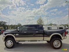 a large black truck parked in a parking lot