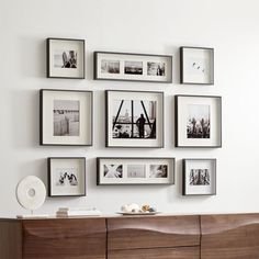 a living room with pictures on the wall and an entertainment center in front of it