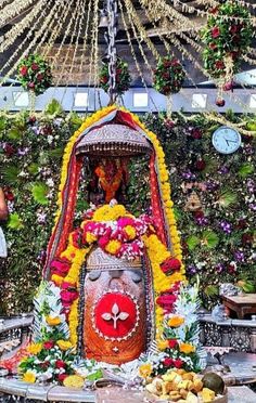 a decorated stage with flowers and garlands on the ceiling is seen in this image