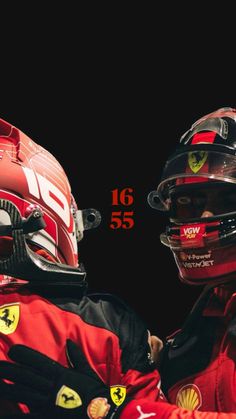 two men in red racing suits and helmets facing each other with the words ferrari on them