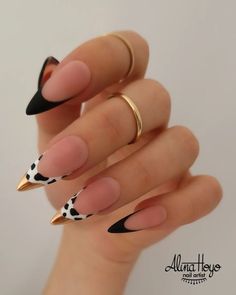 a woman's hand with some black and white nails