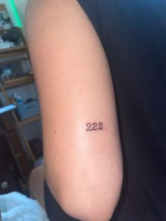 a person with a tattoo on their arm that reads 22 2 and has the number twenty seven