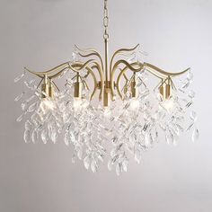 a gold chandelier with crystal drops hanging from it