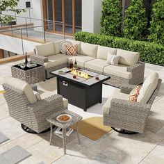 an outdoor living room with furniture and fire pit