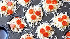 mini pizzas with cheese and pepperoni in muffin tins on a baking tray