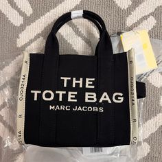 New! Comes With Black Strap To Wear As Crossbody White Tote Shoulder Bag With Logo Hardware, Black Tote Bag With Logo Hardware, Canvas Shoulder Bag With Logo Hardware For Shopping, White Travel Bag With Logo Hardware, White Shoulder Bag With Logo Hardware For Shopping, Black Shoulder Bag With Logo For Errands, Marc Jacobs Tote Bag, Marc Jacobs Tote, Small Tote Bag