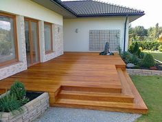 a wooden deck in front of a house