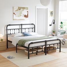 a bedroom with white walls and wood floors, a bed frame is made in metal