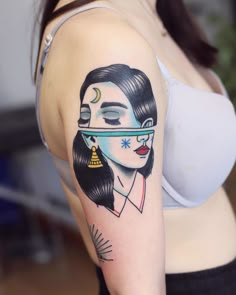 a woman's arm with a tattoo on it that has an image of a woman wearing