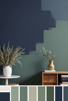 a living room with blue walls and white vases filled with plants on top of a table