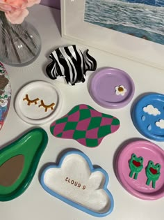 there are many different items on the table together, including buttons and magnets that look like animals