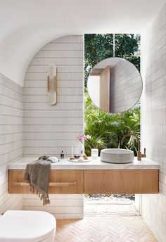 a bathroom with a sink, mirror and bathtub in it's center area