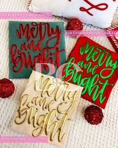 three different types of handmade christmas cards on a white blanket with red and green lettering