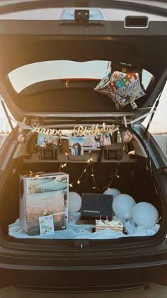 the trunk of a car is filled with items for an upcoming baby's arrival