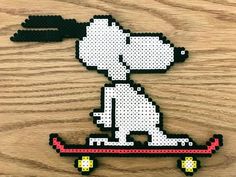 a piece of art made to look like a dog riding a skateboard on wood