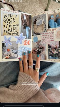 a woman's hand holding an open book with pictures and words on the pages