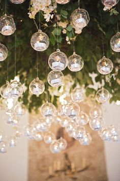 a chandelier filled with lots of glass balls hanging from it's ceiling